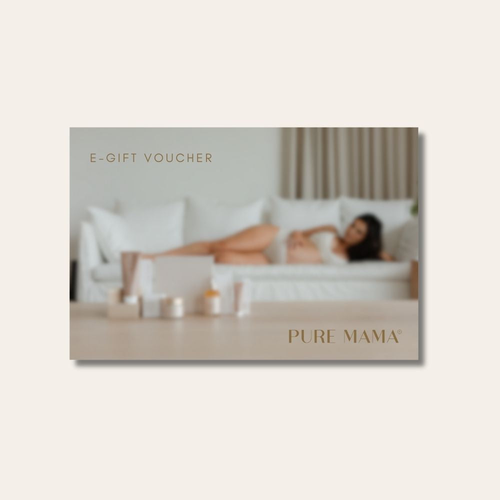 A blurred image depicts a woman relaxing on a white sofa with skincare products in view. The overlay text says PURE MAMA Gift Voucher and Pure Mama NZ, set against soft, neutral hues—ideal for gifting someone special.