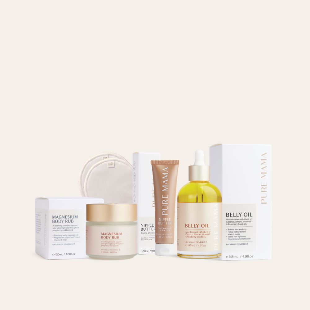 The Essentials Set by Pure Mama NZ features skincare must-haves including magnesium body rub, nipple butter, belly oil, and reusable pads in neutral-toned packaging. These products are elegantly displayed with complementary boxes in the background.