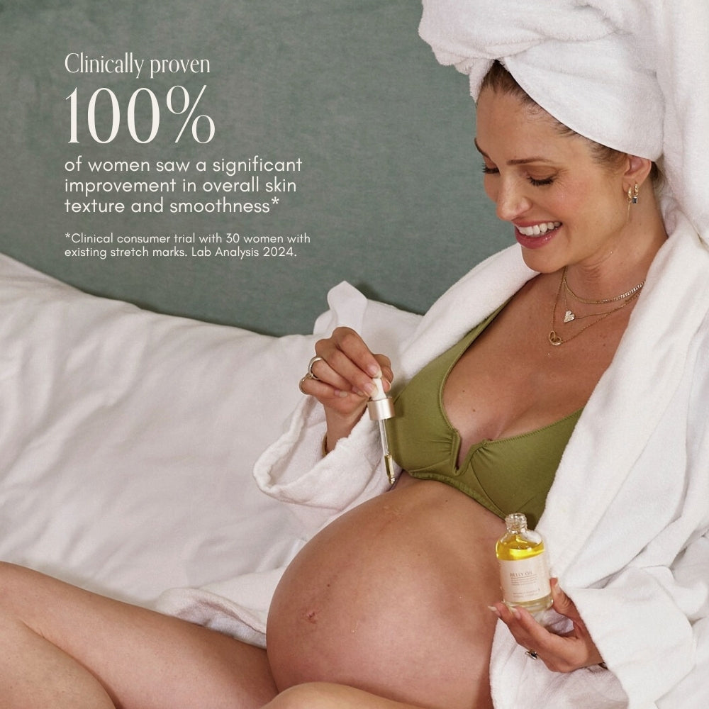 A smiling pregnant woman in a green bikini top and white robe applies Pure Mama NZs Belly Spa Kit oil to her belly, with text highlighting clinically proven skin improvement for women.