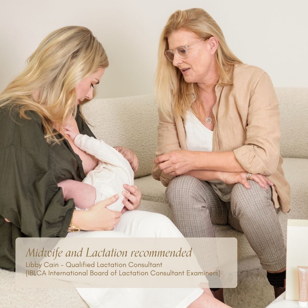 A woman breastfeeds on a couch, supported by a lactation consultant. Text overlay suggests lactation support and recommends Pure Mama NZ Nipple Butter—ideal for breastfeeding mothers seeking comfort and expert guidance.
