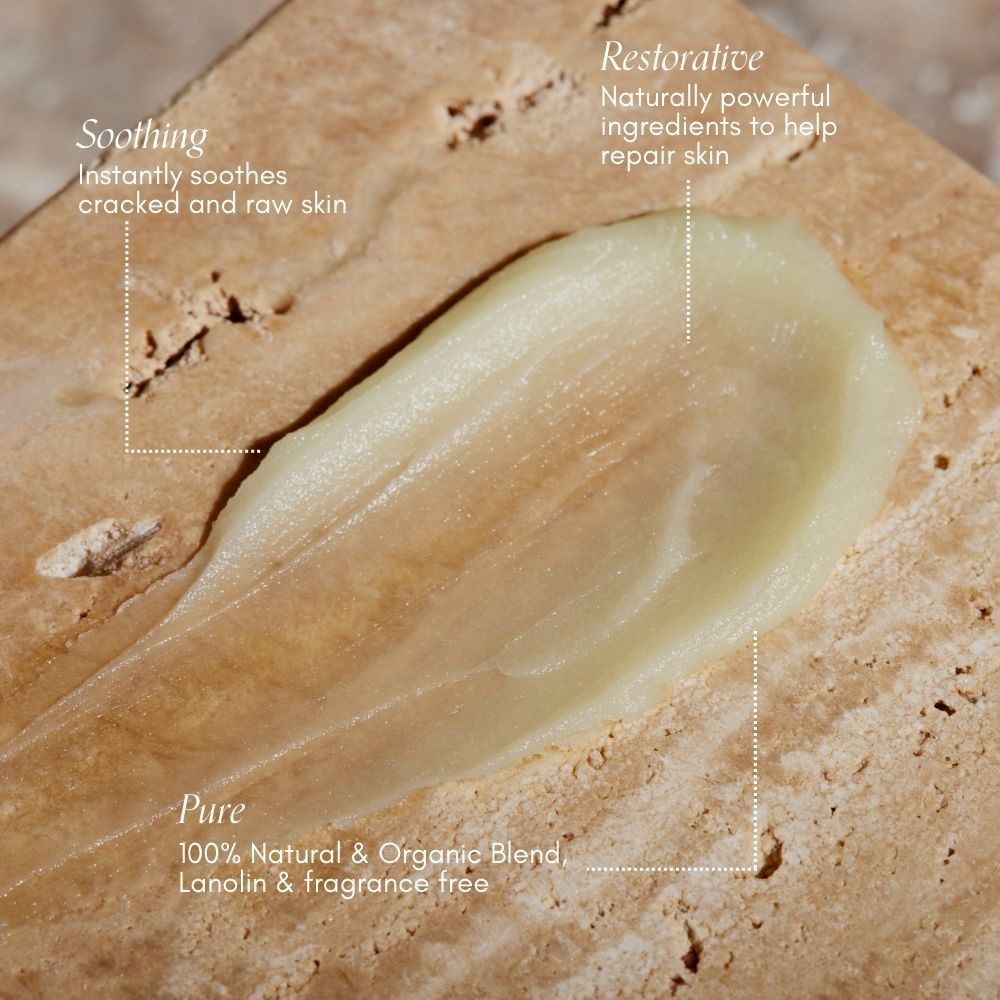 A close-up of Pure Mama NZs Nipple Butter on stone highlights its soothing properties for cracked skin, nourishing ingredients for repair, and emphasizes its 100% natural and organic composition, ideal for breastfeeding mothers.