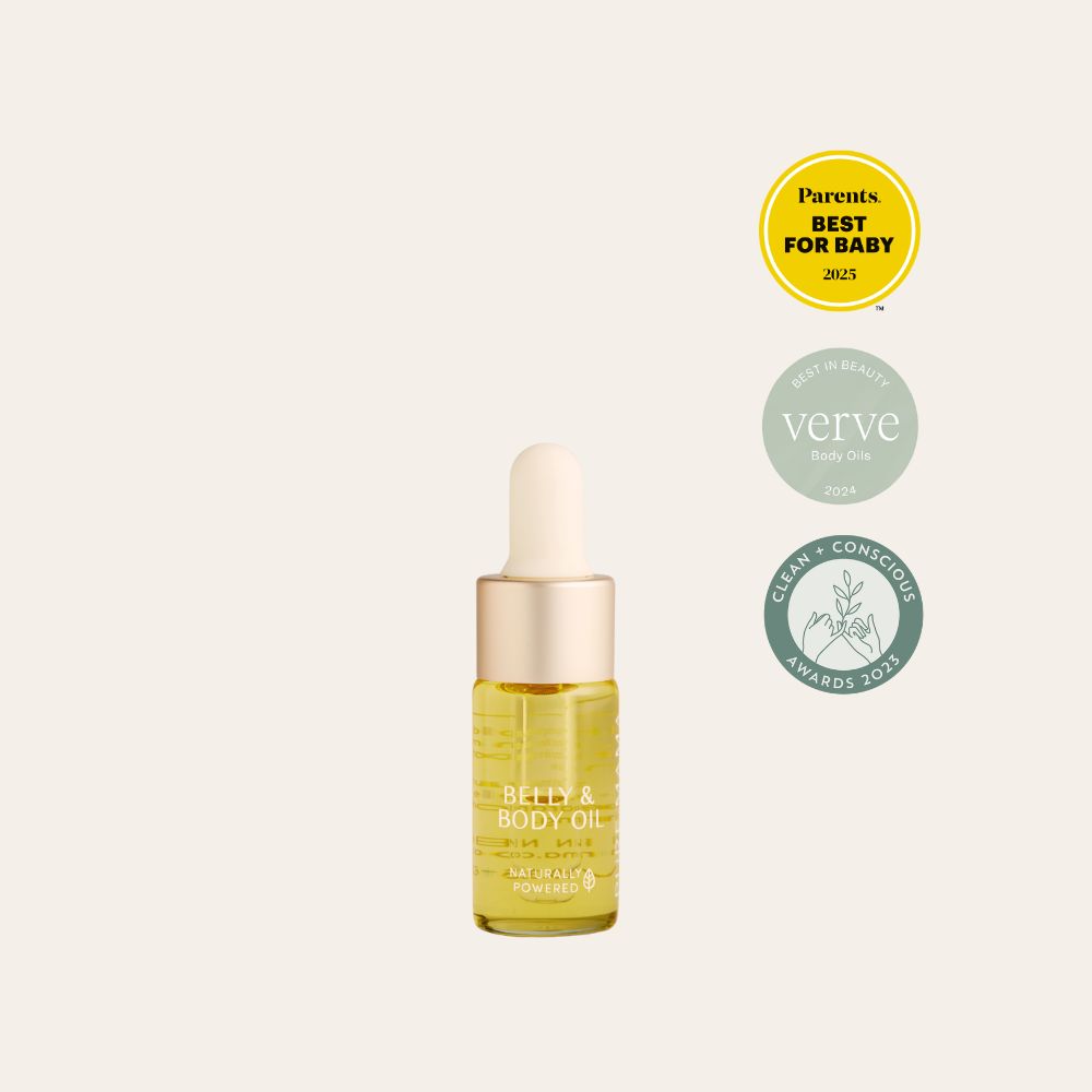 Pure Mama NZ’s Belly Oil Mini, featuring a dropper cap, is centered on a light background beside three badges celebrating its 2023 and 2024 awards in baby, beauty, and conscious product categories.